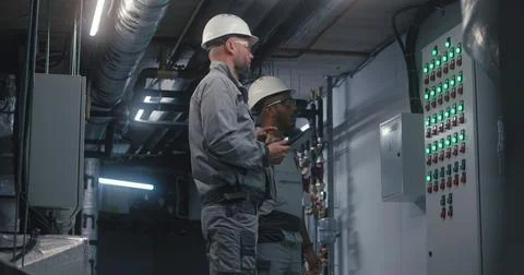 Professional Caucasian engineer uses digital tablet computer 写真素材