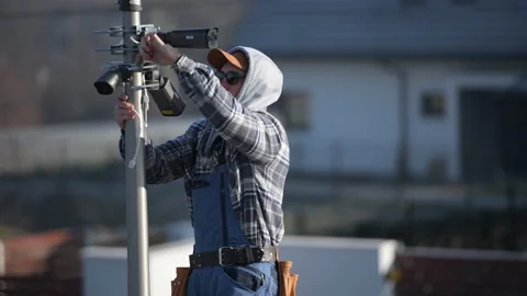 Professional CCTV Technician Installing IP Cameras Stock Footage 147850264