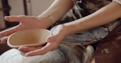 Professional ceramist at work taking handmade cup in studio Stock Footage 208076211