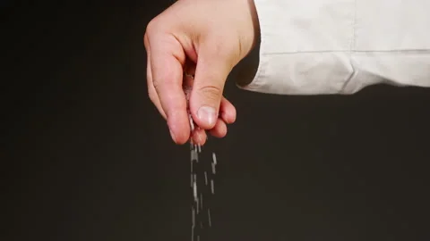 Professional Chef adding salt close-up, a pinch of seasoning. Man cooking dishes Stock Footage 160417637