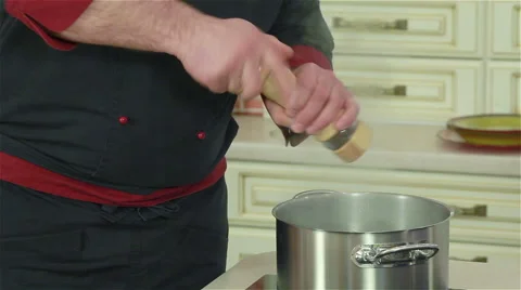 Professional chef adding salt, pepper and spices to meal Stock Footage 50757595