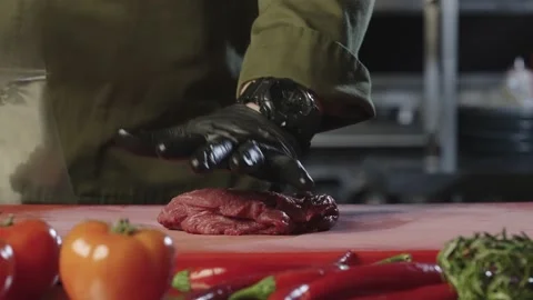 A professional chef beats meat with a hammer on a cutting board. Stock Footage 231717890
