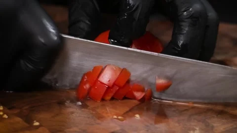 Professional Chef in Black Gloves Slicing Ripe Red Tomato on Wooden Cutting Boar Stock Footage 331636149