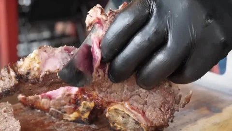 Professional Chef in Black Gloves Slicing Juicy Grilled Beef Steak on Wooden Boa Stockbeeldmateriaal 338211053