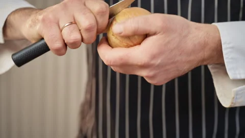 Professional Chef Carefully Peeling Onion Stock Footage 325844153