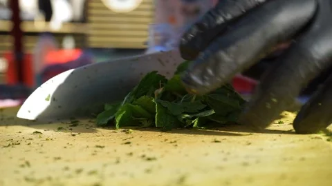 Professional chef chopping up mint on a chopping board. Video stock 92234676