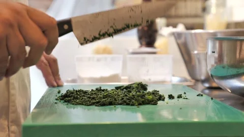 Professional chef is chopping spinach with knife Stock-Footage 131057359