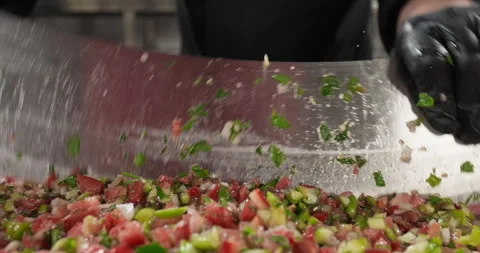 Professional chef chopping vegetables with a big knife, preparing traditional Stock Footage 293809469