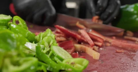 Professional chef chopping vegetables red bell pepper on a cutting board Stock Footage 286360868
