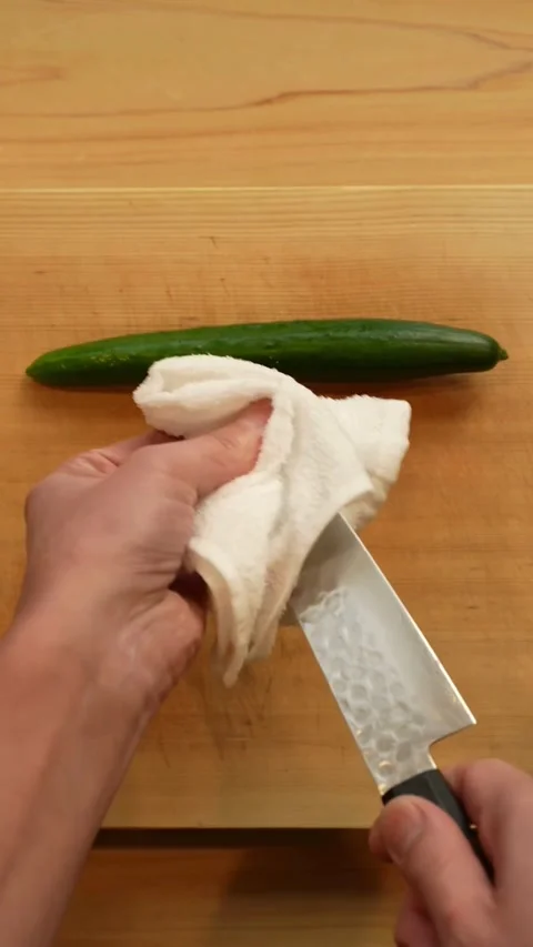 Professional chef cleans a sharp knife with white cloth Stock Footage 331770366