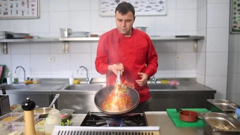 Professional Chef in a Commercial Kitchen Cooking Flambe Style Slow Motion Stock Footage 83645016