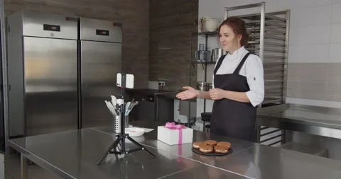 A professional chef conducts a master class and flips through the touch screen Stock Footage 171615977