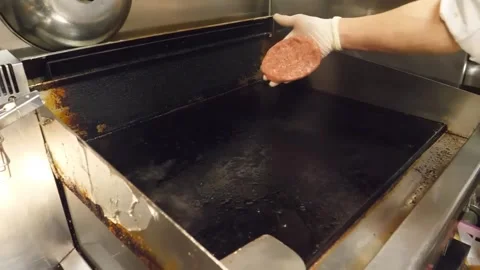 Professional Chef Cooking Beef Burger Patty on Commercial Flat Top Grill - Close Stock-Footage 347687845