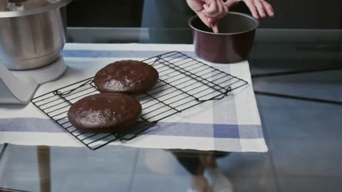 Professional chef is cooking cake. Young attractive housewife check cooked cake Stock Footage 132428418