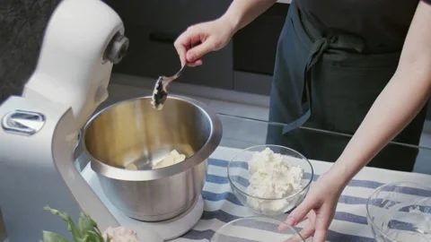 Professional chef is cooking cake. Young attractive housewife puts ingredients Stock Footage 132428666