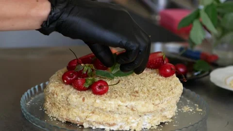 A professional chef cooking dessert in the kitchen. Flour layer cake with fruit. Stock Footage 158105478