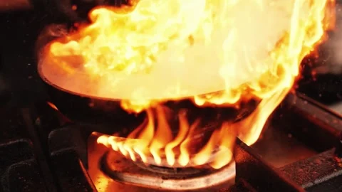 Professional Chef Cooking with Dramatic Flames Stock Footage 338217094