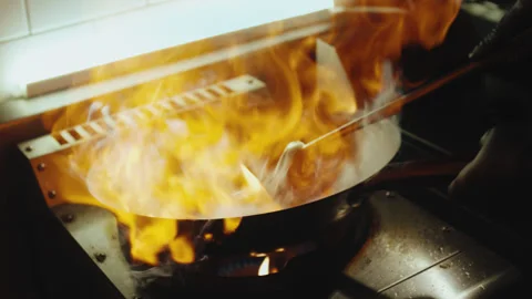 Professional Chef Cooking with Large Fire Flame in Wok Pan Stock Footage 321860504