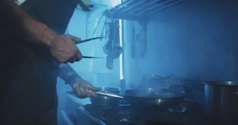 Professional chef cooking meat on fire stove Stock Footage 203557590