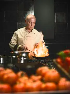Professional chef cooking Stock Photos
