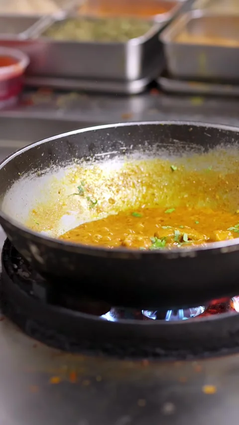 Professional Chef Cooking Yellow Curry in Commercial Kitchen Pan Stock Footage 340862578