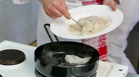 Professional Chef Cooks Fish in a Pan in Slow Motion Stock Footage 60612011