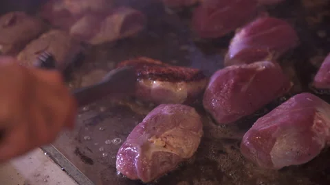 Professional chef cooks steaks on restaurant kitchen griddle Stock Footage 167340325