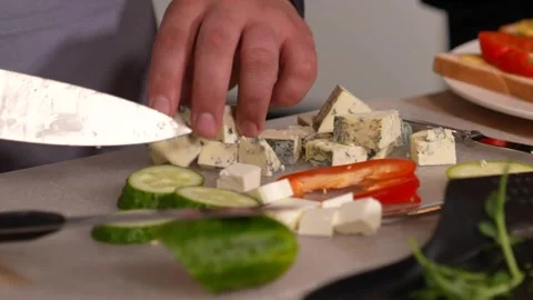 A professional chef cuts blue cheese for salad with vegetables. Stock Footage 244484270