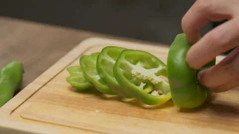 Professional chef cuts green bell pepper. Slow motion. Stock Footage 138631259