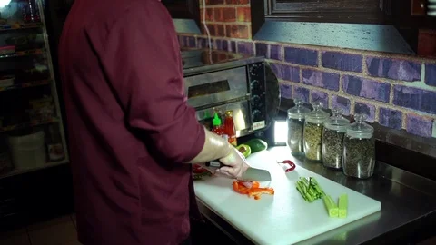 Professional chef cuts red pepper on white board Video stock 106389048