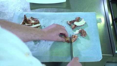Professional chef cutting a boiled octopus Stock Footage 71604536