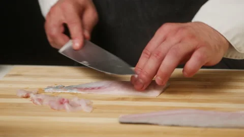 Professional Chef cutting raw white fish close-up, thin slices. Man cooking Stock Footage 160417704