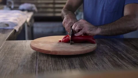 Professional chef cutting red pepper Stock Footage 143938753