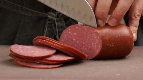 The professional chef is cutting the sausage. Stock Footage 160968034