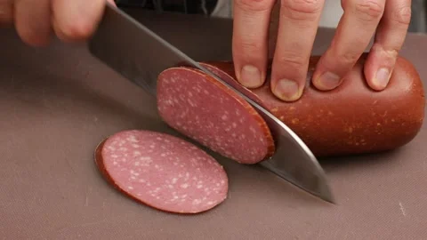 The professional chef is cutting the sausage. Stock Footage 160968144