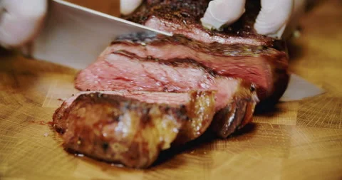Professional chef is cutting tomahawk steak Stock Footage 88962038