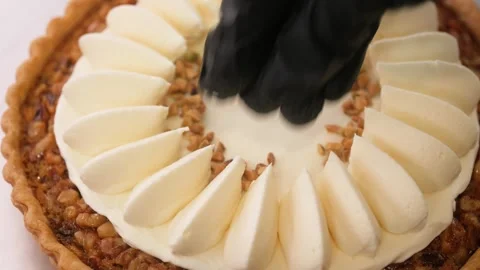 Professional Chef Decorating Gourmet Caramel Walnut Tart with Cream Petals Stock Footage 337751523