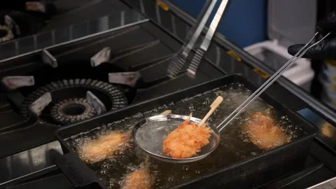 Professional Chef Deep Frying Kushiage Skewers in Commercial Kitchen Stock Footage 337440596