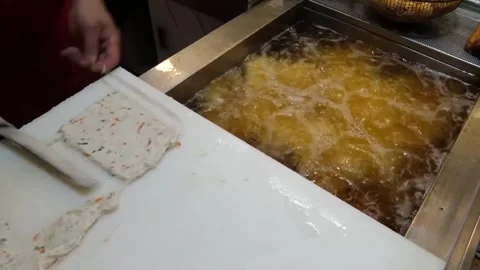Professional Chef Deep Frying Traditional Korean Fish Cakes (Eomuk) at a Busy St Stock Footage 337372880
