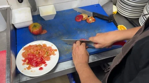 Professional chef dicing fresh heirloom tomatoes for a recipe 스톡 동영상 344100071