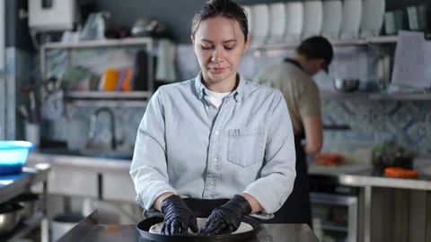 Professional chef expertly preparing exquisite dishes in modern stylish kitchen Stock Footage 296634603