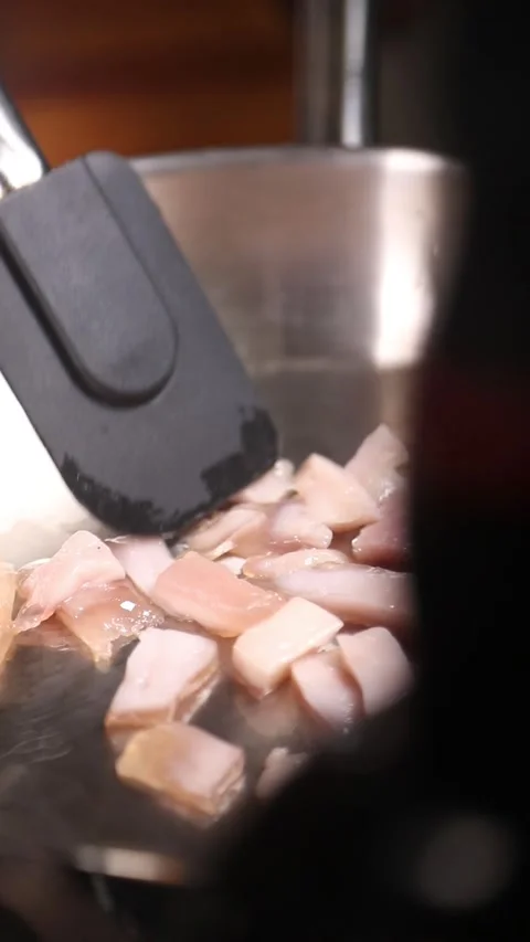 Professional chef frying Iberian ham fat in a stainless steel pan. Stock Footage 335653541