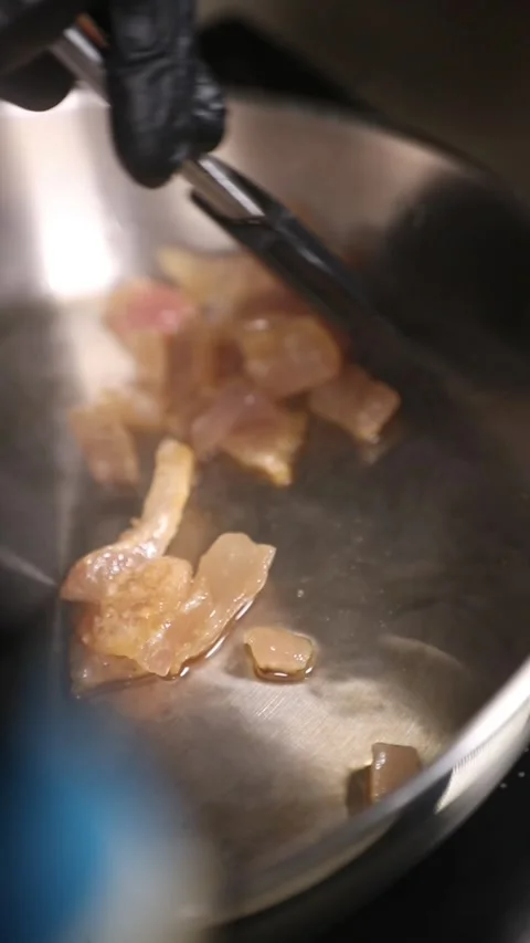 Professional chef frying Iberian ham fat in a stainless steel pan. Stock Footage 335653554