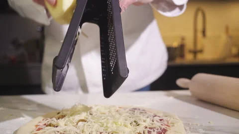 Professional Chef Grates Cheese On Pizza Cooking Traditional Italian Meal. Stock-Footage 169878363