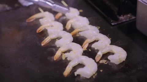 Professional Chef Grilling Fresh Shrimp on Hot Flat Top Griddle Stock Footage 337440459
