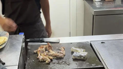 Professional chef grilling meat and fish on a teppanyaki grill Stock-Footage 344100232