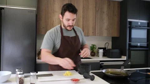 Professional chef grinding spices in kitchen Stock Footage 340221152