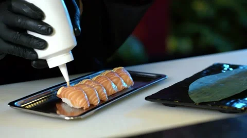 Professional chef hand decorate salmon sushi roll with shrimp tempura Stock Footage 239096948