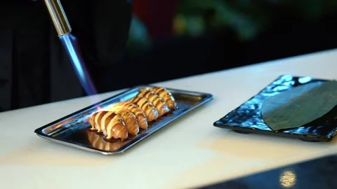 Professional chef hand use butane torch burner burning salmon Stockbeeldmateriaal 239097332