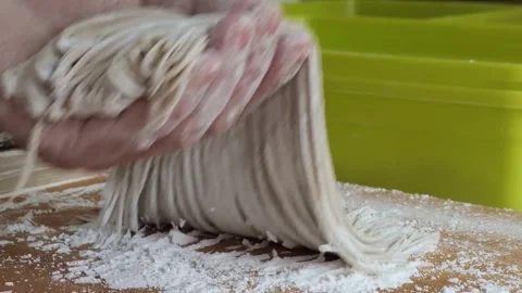 Professional Chef Hands Gathering Fresh Handmade Soba Noodles on a Floured Woode Stock Footage 333523822